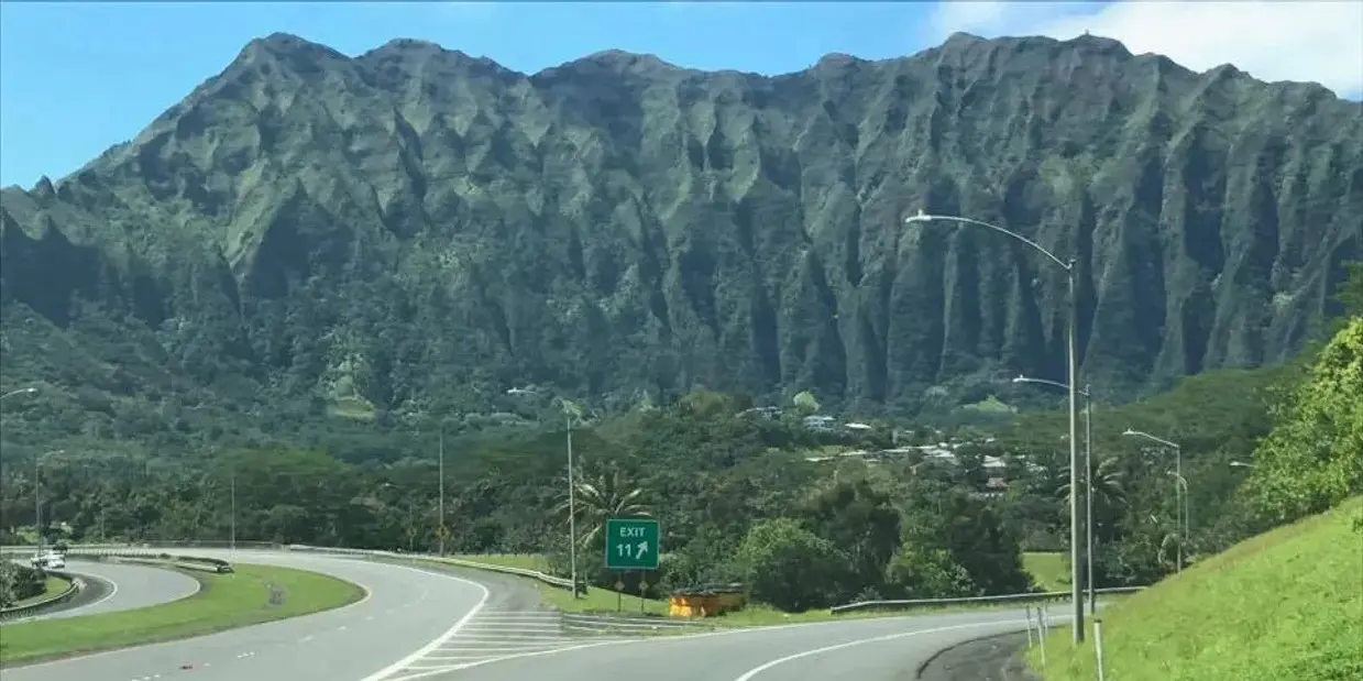 A highway with mountains in the background