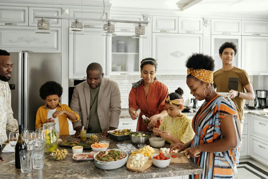 A group of people standing around a table.