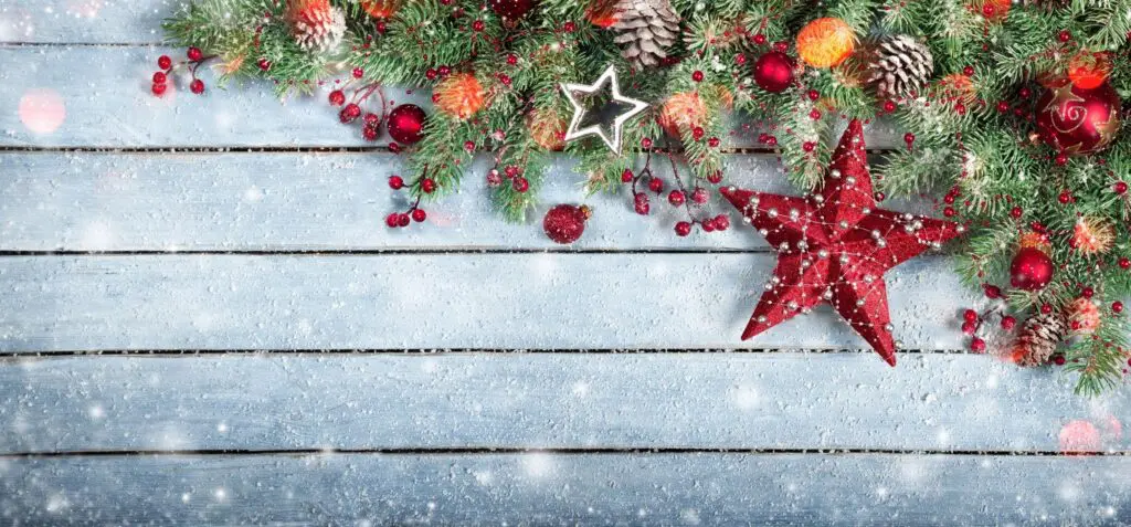 A wooden table with christmas decorations on it.