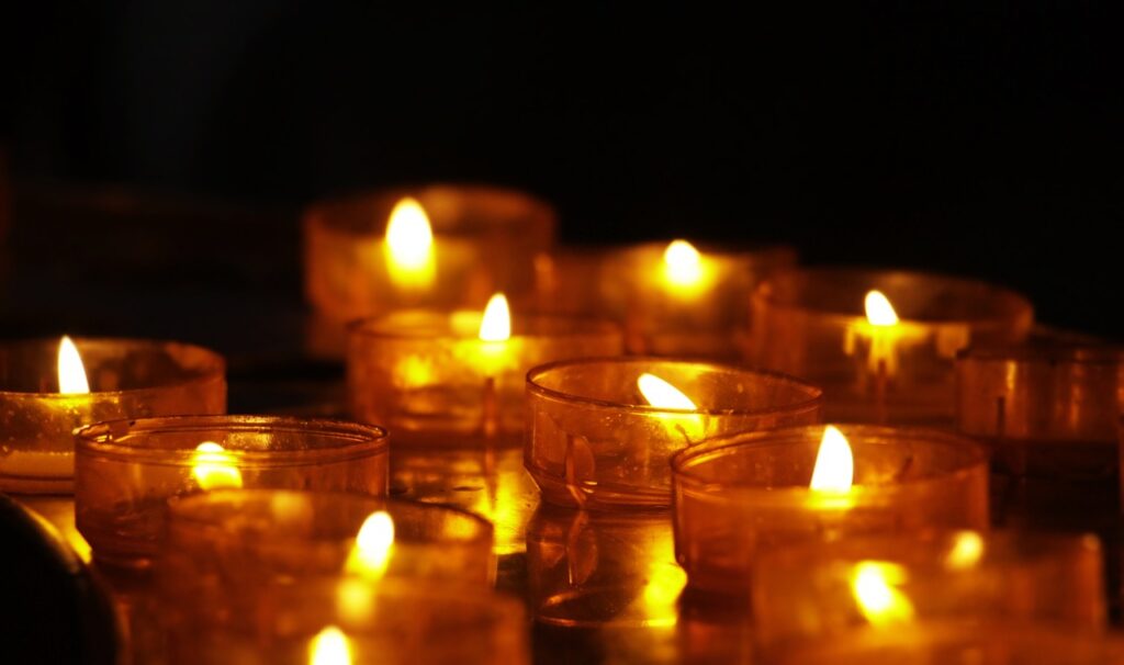 A group of lit candles sitting on top of a table.