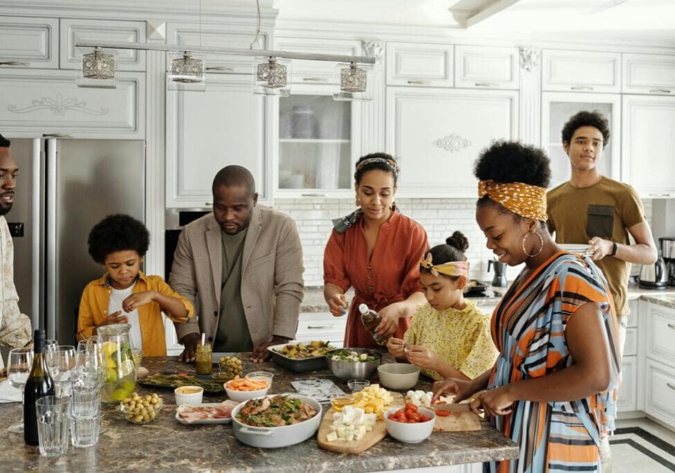 A group of people standing around a table.