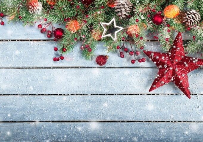 A wooden table with christmas decorations on it.