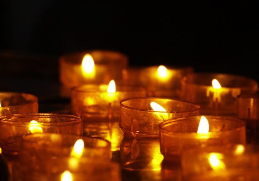 A group of lit candles sitting on top of a table.